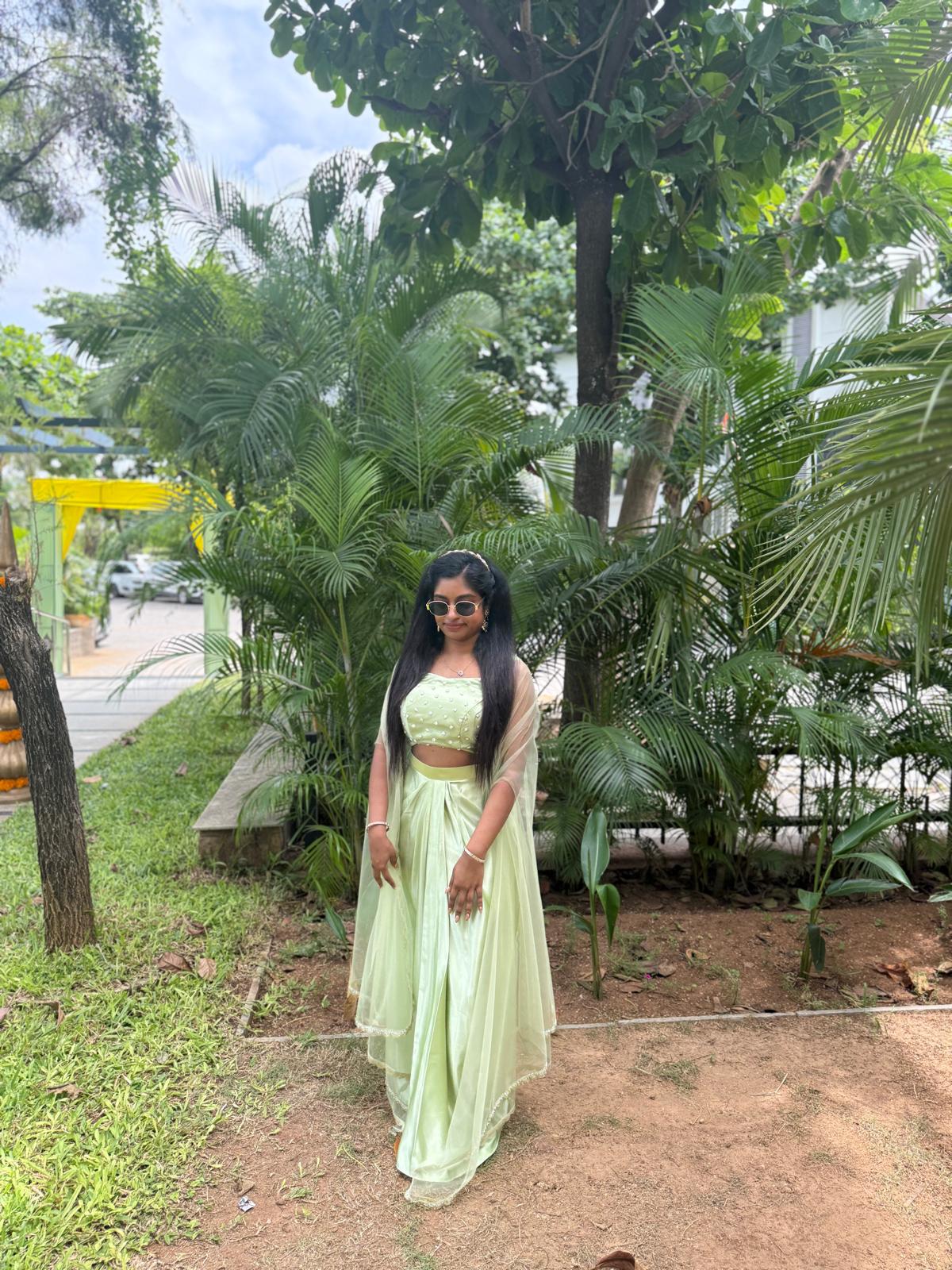Mint green draped lehenga and blouse with a sheer dupatta