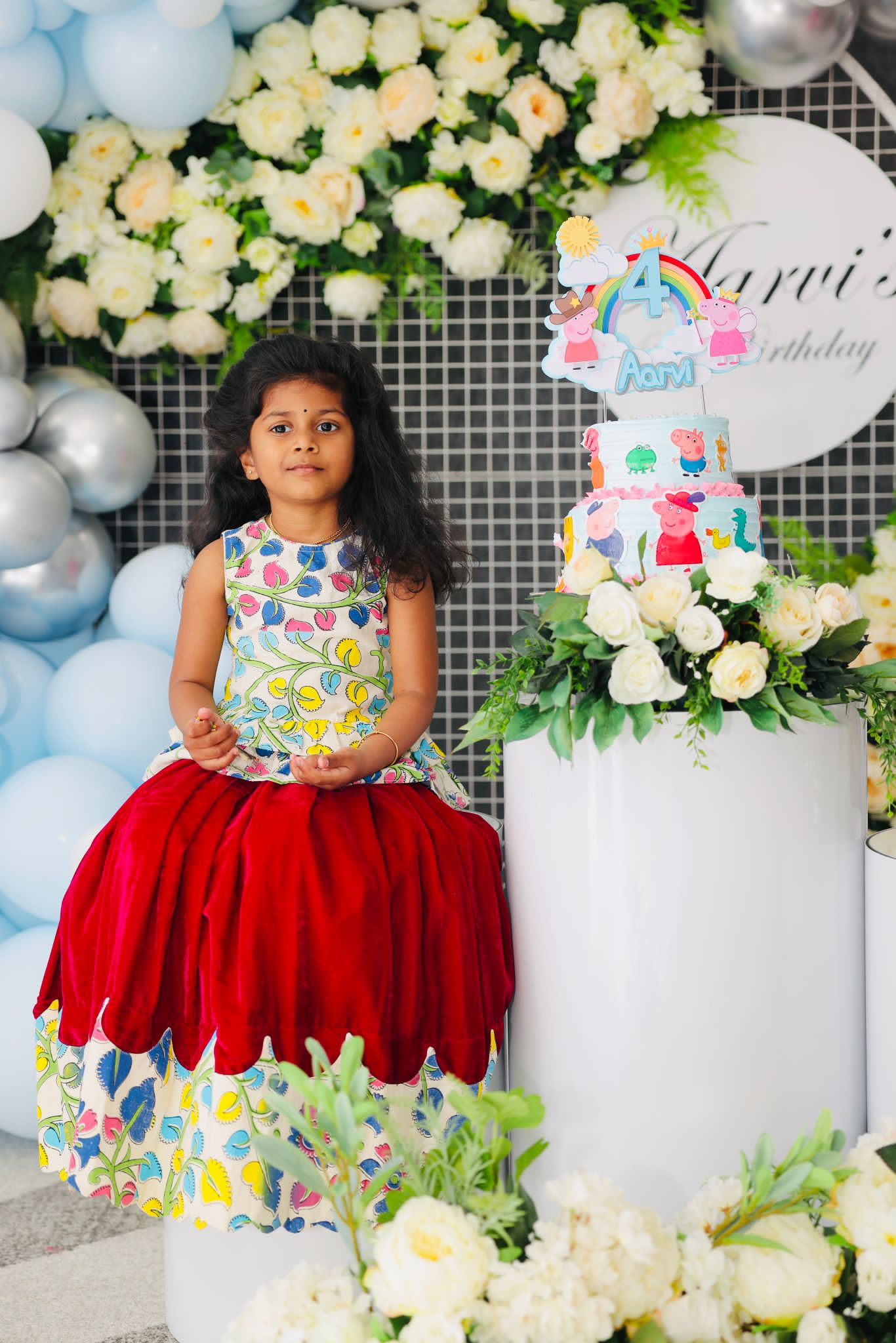 Red and printed girls occasion dress with a petal-shaped skirt